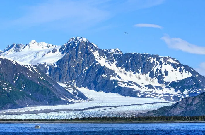 Snow-capped mountains with a glacier view over a pristine lake, capturing amazing views in natural states.