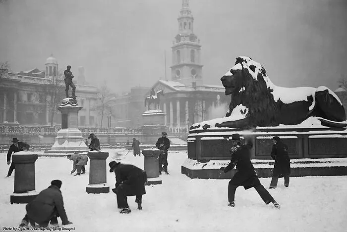 A Group Of Gents Enjoy An Impromptu Snowball Fight In The Serene And Stately Setting Of Trafalgar Square, London, Circa 1931