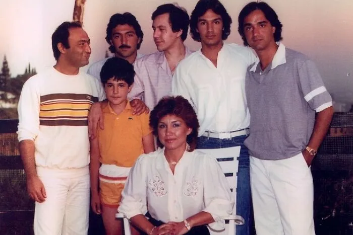 Group photo showcasing people in 80s fashion trends with vibrant and casual clothing outdoors.