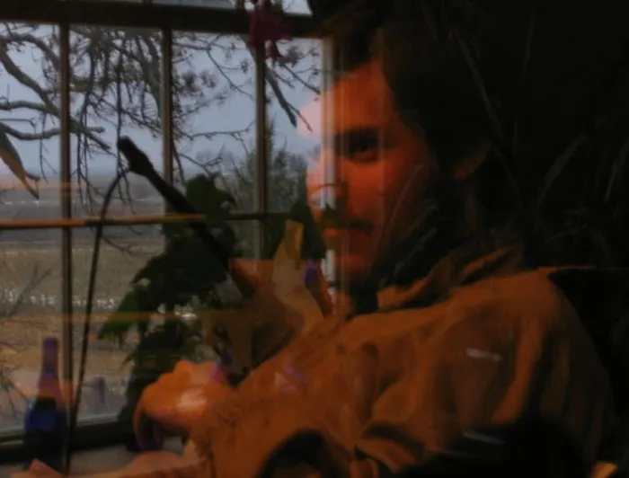 Not A Double Exposure.  Guy Behind Glass In Studio Control Room With Reflection From Nearby Window Reflected In It