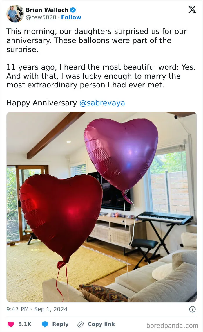 Heart-shaped balloons in a living room, part of a funny and wholesome anniversary surprise.