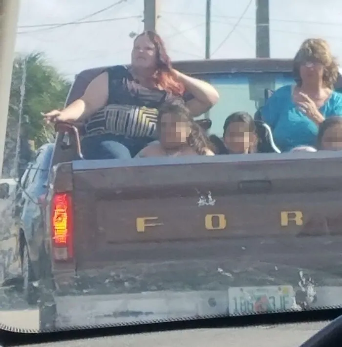 Saw This Today While Driving On A Major Road. They Had Three Kids In The Bed And The Two Women Are Sitting On Lawn Chairs. Bonus Points For The Cigarettes Too