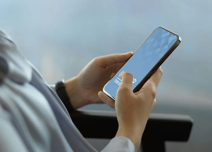 Person holding a smartphone, possibly engaged in nostalgic browsing related to peaking in high school.