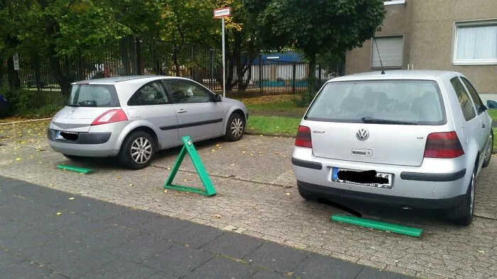 These Parking Spaces Have Folding Bars That Lock To Keep People From Parking In Their Spots