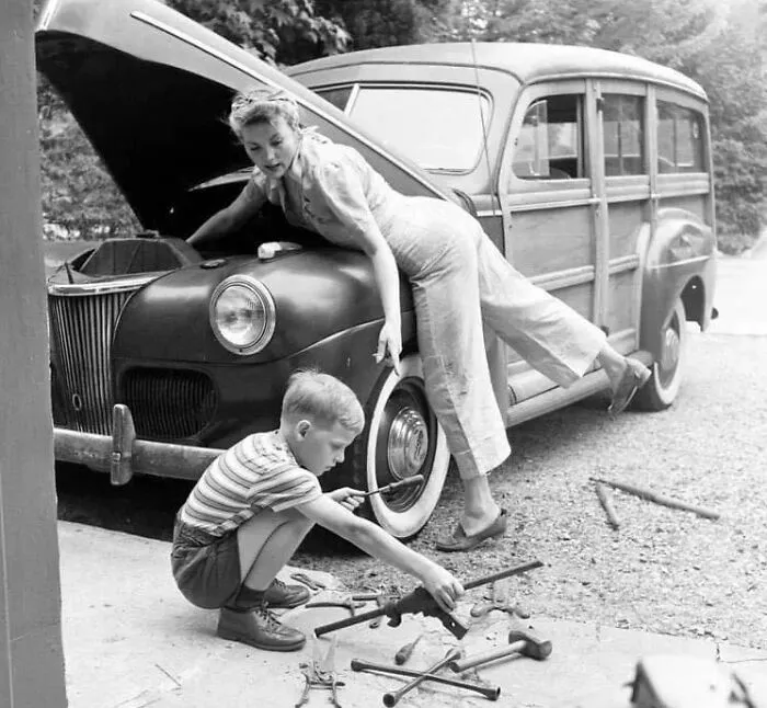 A Mother Repairs The Family Car While Her Husband Is Away At War, 1944
