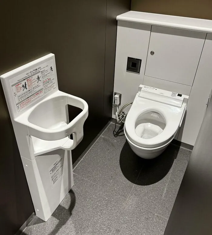 Modern toilet in Japan with an attached baby seat, showcasing unique Japanese restroom design.
