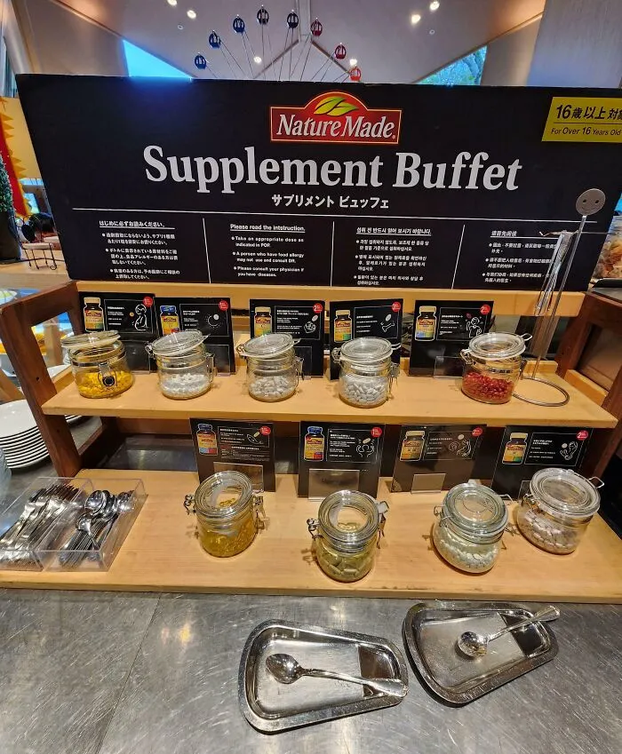 Supplement buffet display in Japan with jars of vitamins and instructions, showcasing an interesting part of Japanese culture.