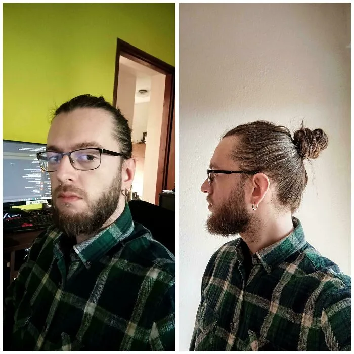 Man with fierceflow hair tied in a bun and beard wearing glasses and a green plaid shirt in indoor settings