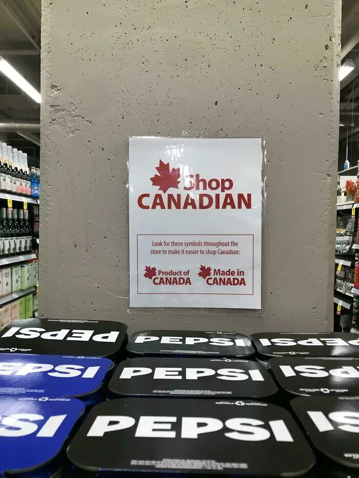 Sign in a store promoting Canadian products with a maple leaf logo and stacked Pepsi packs in the foreground.