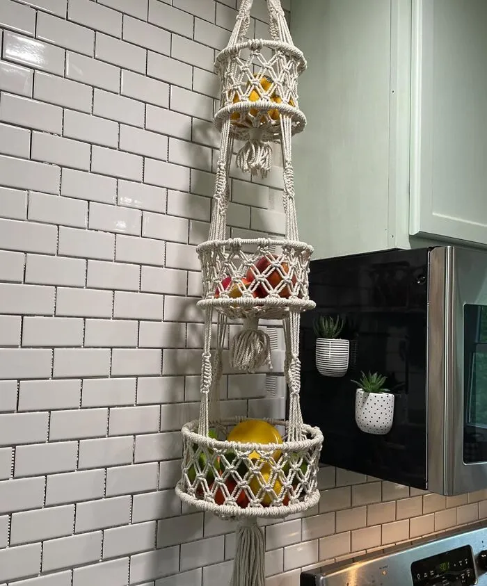 Your Countertop Deserves More Than A Sad Bowl For Oranges—enter This <a Style="Display:inline;" Href="Https://Www.amazon.com/Snuglife-Macrame-Tier-Hanging-Basket/Dp/B08s7f94qp?ie=utf8&linkcode=ll1&tag=bpalpaca-20&linkid=d2a9a27465bc84baa8fe6305fbd148cf&language=en_us&ref_=as_li_ss_tl" Target="_blank"><span Style="Font: Inherit; Color: #d74b1f;"> Macrame Fruit Basket</Span> That’s Basically Boho Chic For Your Bananas