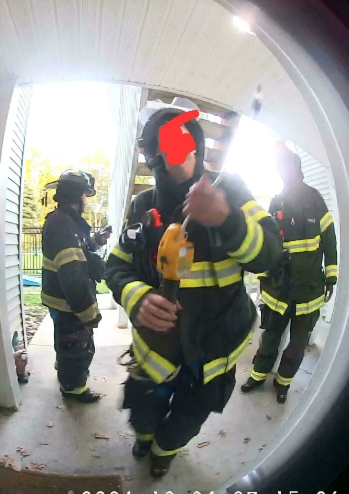 The Yellow Thing In The Firefighters Hand, It Looked Like He Held It Up To My Peep Hole