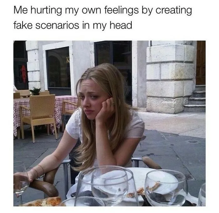 Young woman looking sad at an outdoor cafe, illustrating humor as a coping mechanism with a pensive expression.