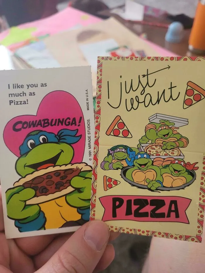Teenage Mutant Ninja Turtles cards featuring pizza, representing moderately interesting collectibles shared by people worldwide.