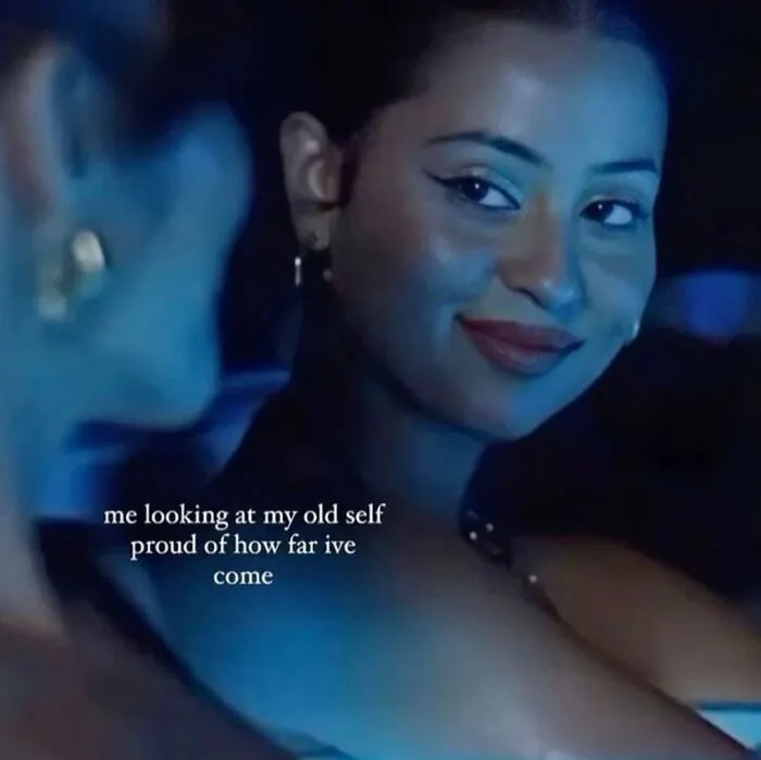 Woman smiling with caption "me looking at my old self, proud of how far I've come" representing girly meme.
