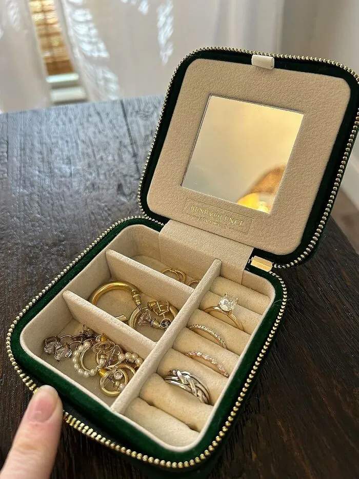 Jewelry box with rings and earrings, combining usefulness with aesthetic appeal on a wooden table.