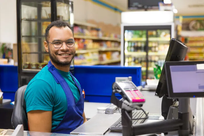 Cashier in a grocery store, representing common USA things that might confuse foreigners.