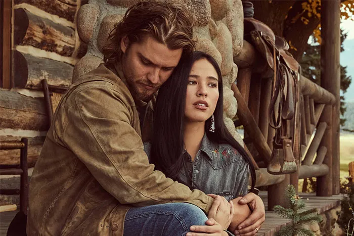 A couple embraces on a rustic porch, representative of TV couples with little chemistry.