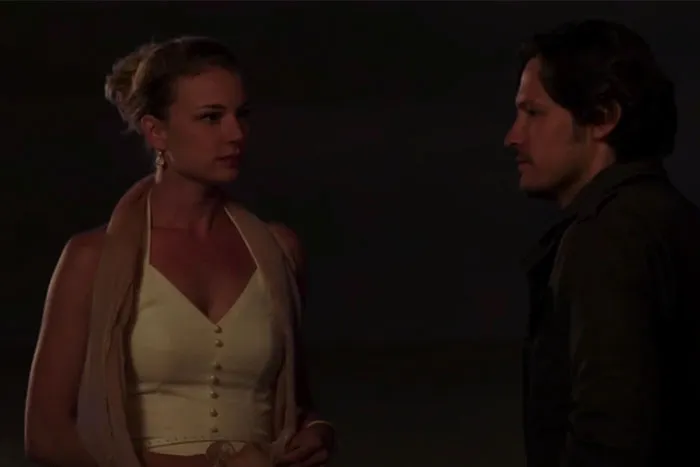 TV couple with less chemistry having a serious conversation at night.