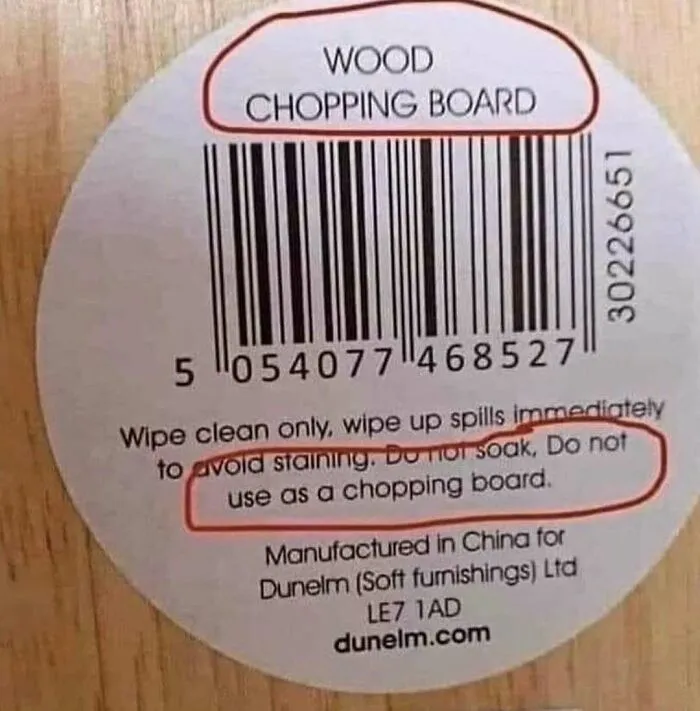 Label on a wood chopping board with a warning not to use it as a chopping board, humor for those who love to cook.