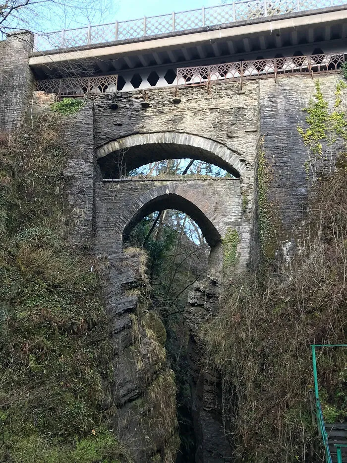 A Historic Journey Of Bridges. Devils Bridge Near Aberystwyth, Wales. The Original Medieval Bridge At The Bottom, The 18c Turnpike Road Bridge In The Middle And The Modern 20c Bridge Above