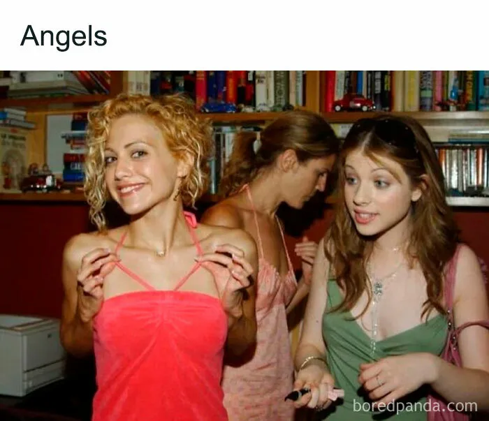 Smiling women at a party, one in a pink dress, embodying girly things with their outfits and expressions.