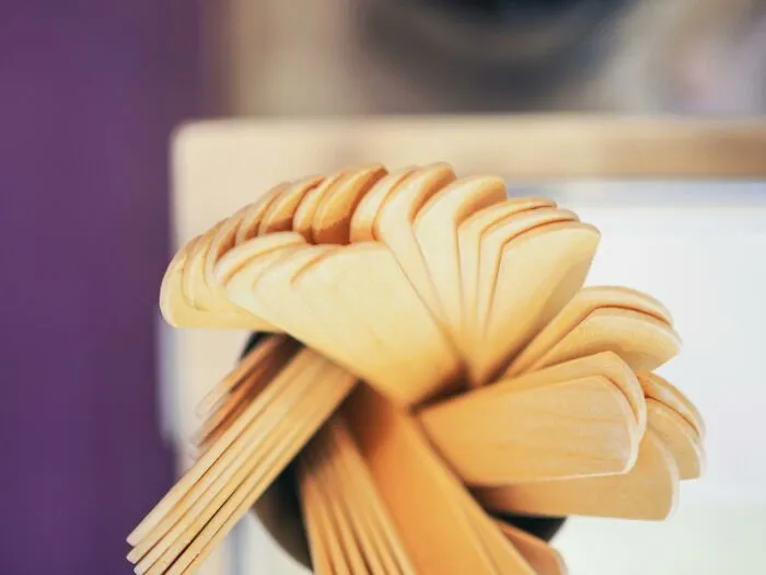 Wooden ice cream sticks in a fan arrangement, often kept for sentimental reasons despite being useless.