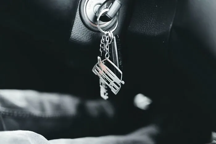 Car keychain with a sentimental van charm in ignition.