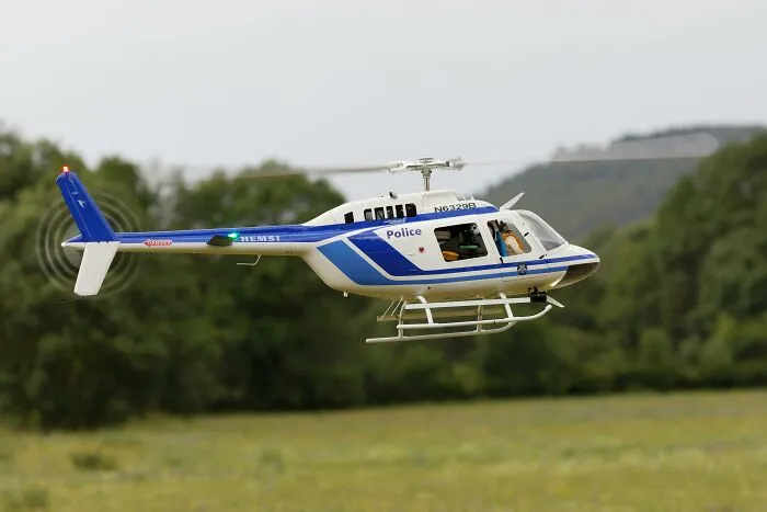 Police helicopter flying over grassy field, possibly involving hilarious overheard conversations.