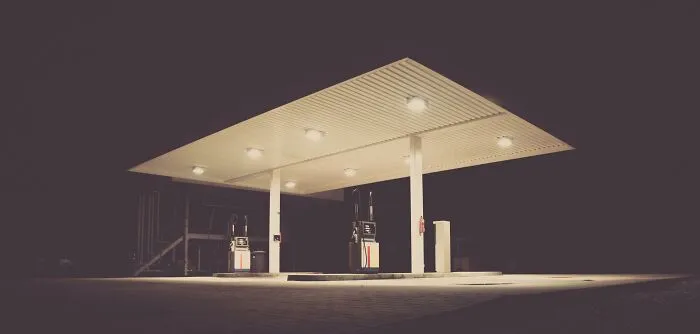 A lone gas station lit up at night, representing improved life simplicity.