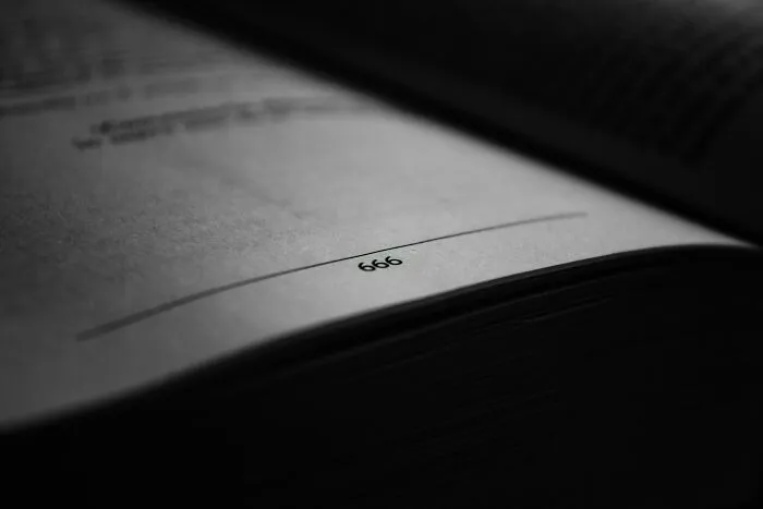 Page number 666 highlighted in a book, symbolizing superstition and its association with bad luck.