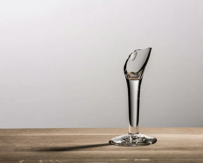 Broken glass on a table, symbolizing superstition about its significance.