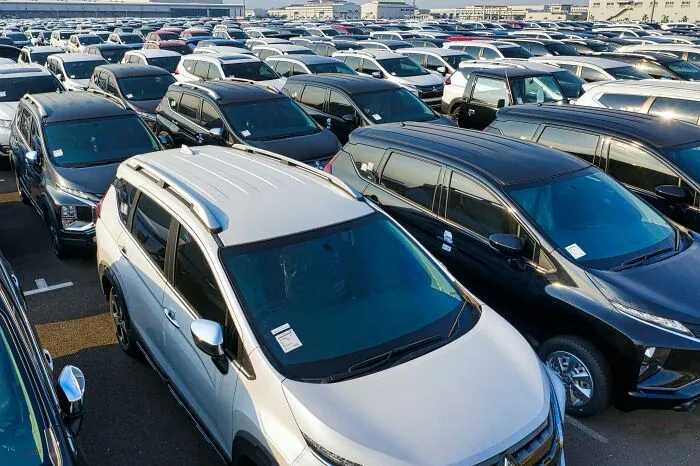 Parking lot filled with cars, illustrating social rules people ignore like improper parking.