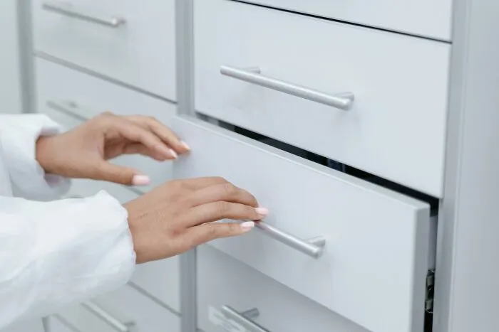 Hands opening a drawer, illustrating the social rules people ignore.