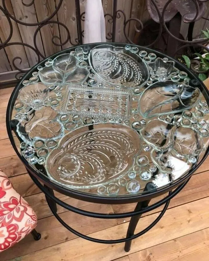 Recycled glass plates form a decorative tabletop design, showcasing creative recycling.