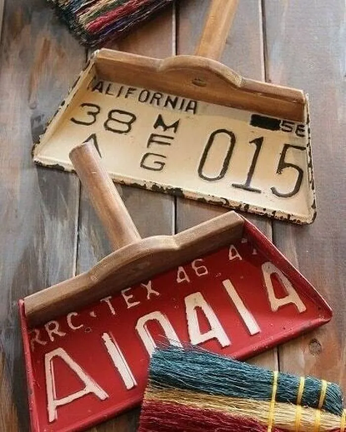 License plate dustpans with colorful brooms, showcasing creative recycling ideas.