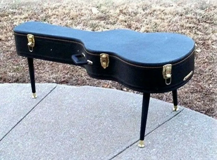 Guitar case repurposed into a creative table, illustrating an inspiring recycling idea.