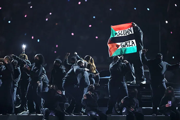 A Protester Is Detained After Holding Up A Flag In Support Of Gaza And Sudan
