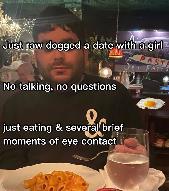 Man at a restaurant with caption text, enjoying a humorous meme moment over pasta.