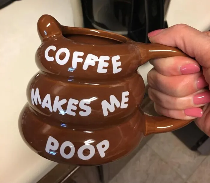 A novelty mug shaped like poop with the text "Coffee makes me poop," showcasing toilet humour.