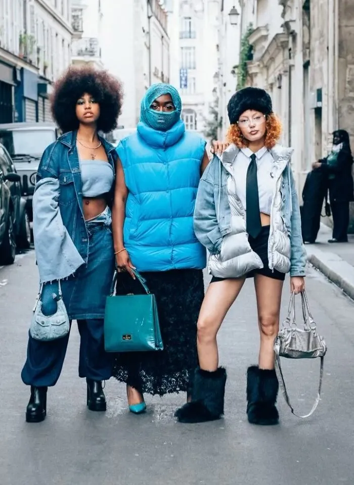 Three stylish strangers in urban street fashion, featuring denim and vibrant accessories, captured as street portraits.