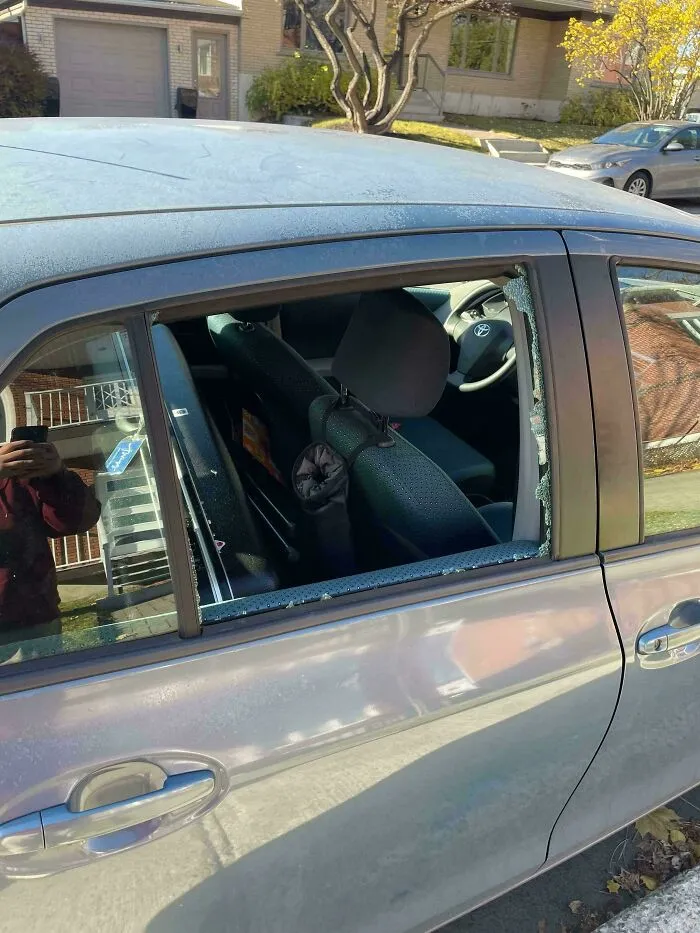 Car window shattered, showing evidence of an expensive accident.