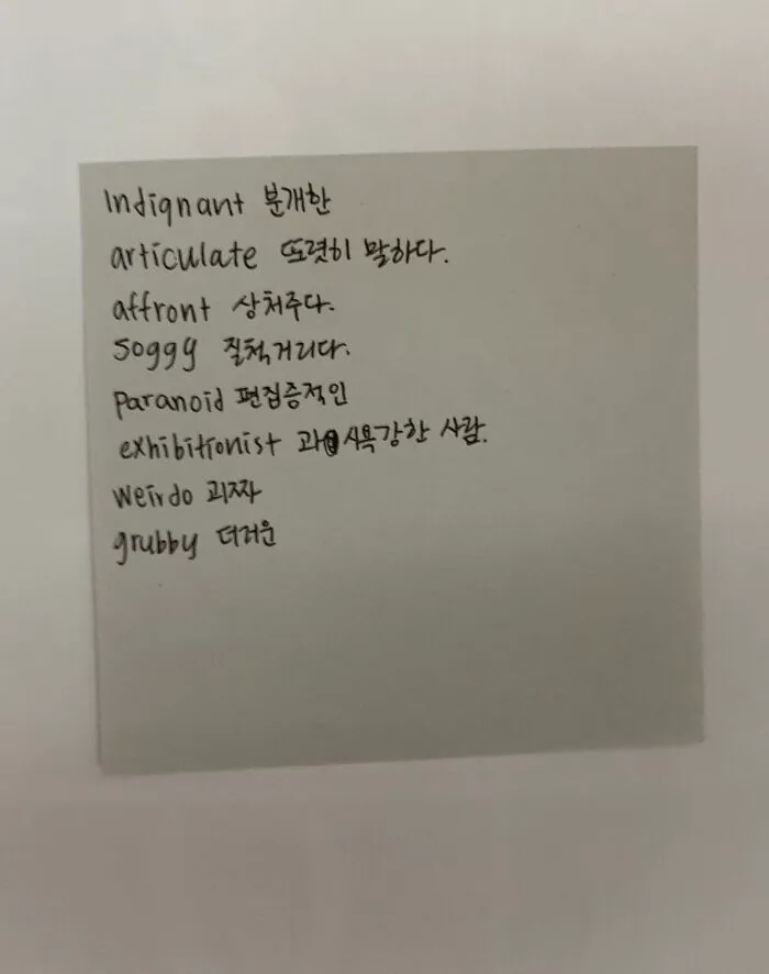 Handwritten notes in English and Korean on a paper square, found inside a book as a unique bookmark.