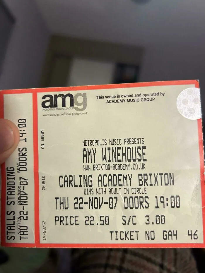 Concert ticket used as a unique bookmark, showcasing book lovers' creativity.