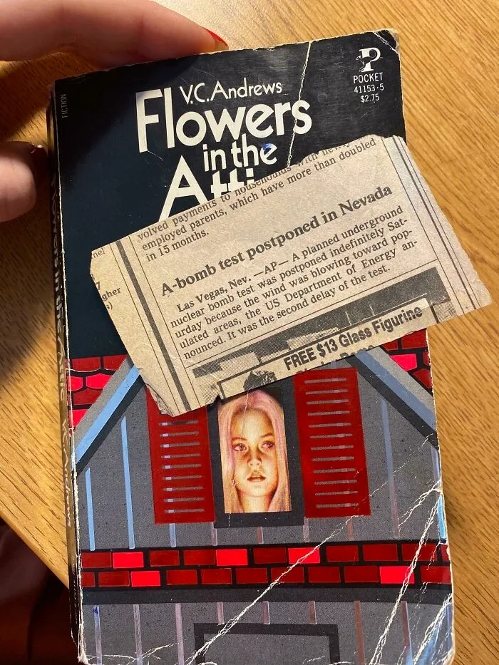 Vintage newspaper clipping bookmark in "Flowers in the Attic" book.