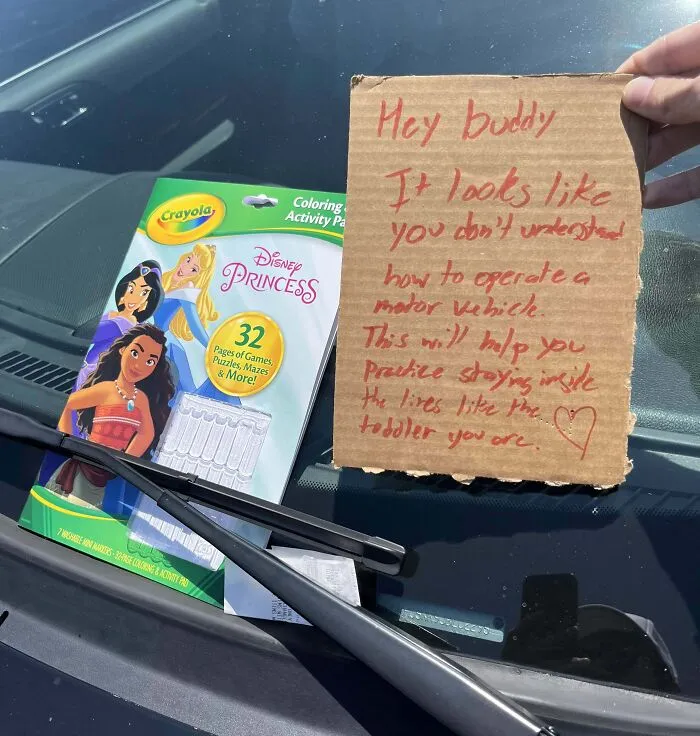 Crayola coloring book with a passive-aggressive note on a car windshield.
