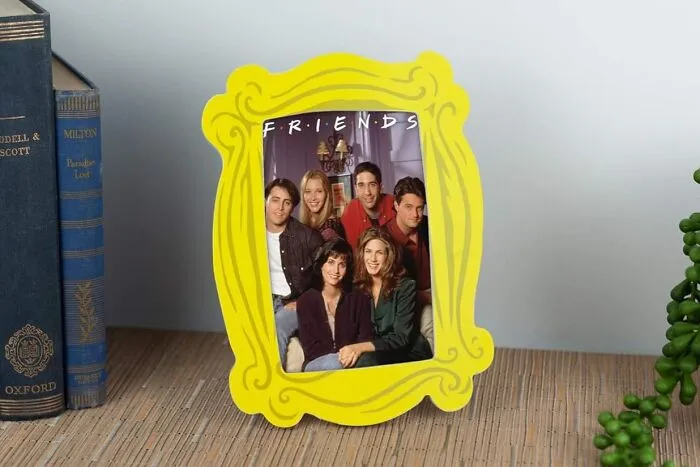 We'll Be There For You...to Hold Your Favorite Memories, In The <a Style="Display:inline;" Href="Https://Www.amazon.com/Silver-Buffalo-Peephole-Merchandise-Frd30547/Dp/B08crzs64g?th=1&linkcode=ll1&tag=bpfrog-20&linkid=93c8e44c00272120fbca6c873f14ffe4&language=en_us&ref_=as_li_ss_tl" Target="_blank"><span Style="Font: Inherit; Color: #d74b1f;"> Yellow Friends Photo Frame </Span>, Where Central Perk Vibes Meet Your Personal Photo Booth