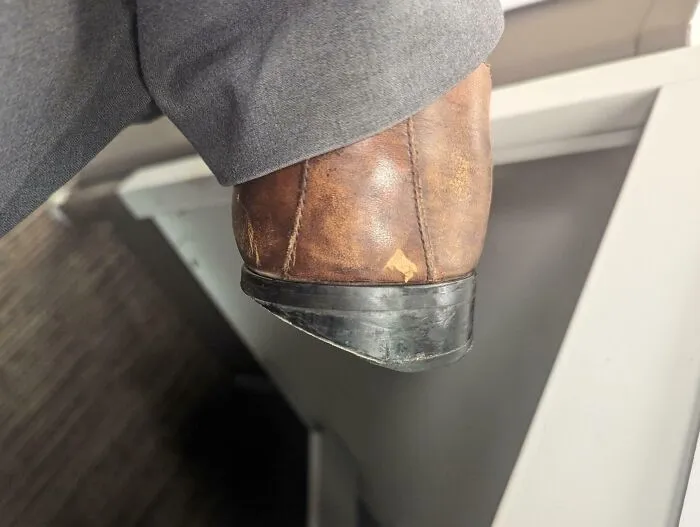 Zapato de cuero desgastado mostrando el efecto del tiempo en los objetos.