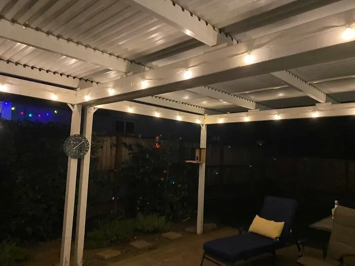 Cozy backyard patio with string lights at night, a spring must-have for outdoor relaxation.