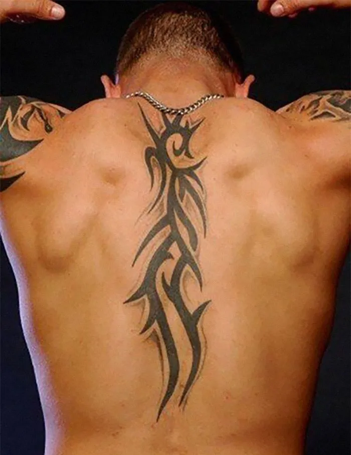 A tribal tattoo design on a person's back, showcasing distinctive ink patterns.