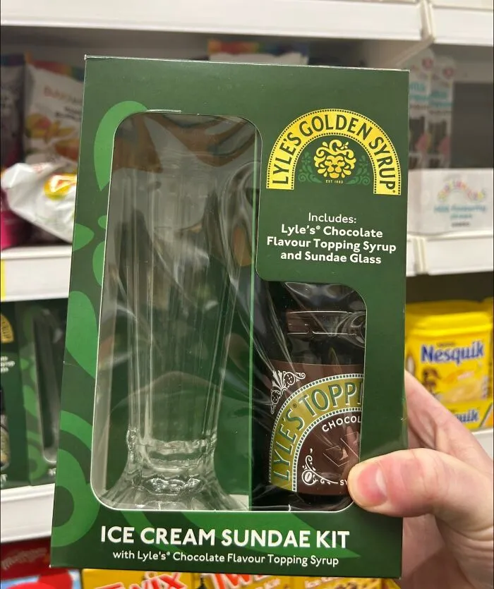 British humor: Ice cream sundae kit with Lyle’s chocolate syrup and glass in a green box on a store shelf.